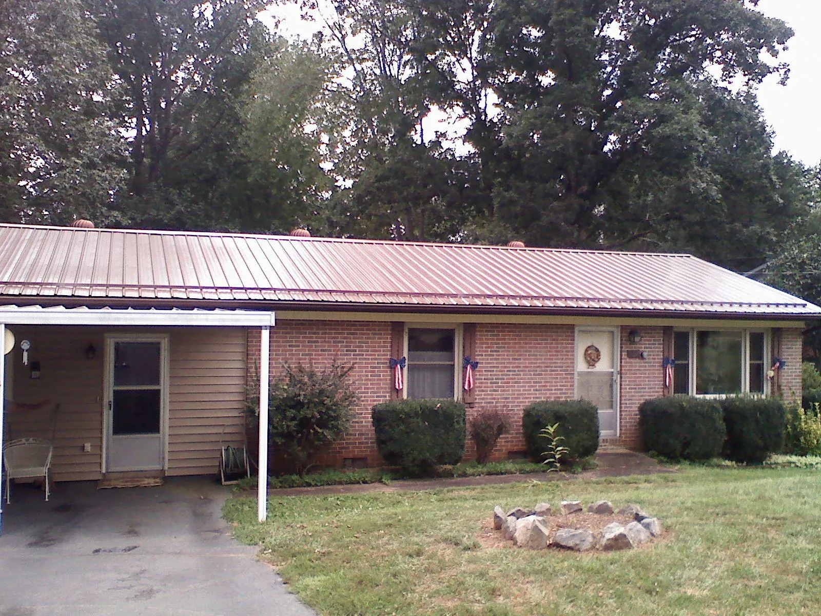 Bronze metal roof and carport on a brick ranch home — Roof Repair work by our crew in Canterbury